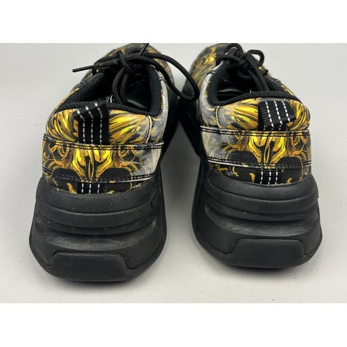 102 - A PAIR OF VERSACE TRAINERS IN BLACK AND GOLD, with 'Medusa heads' on each. 

Some marks