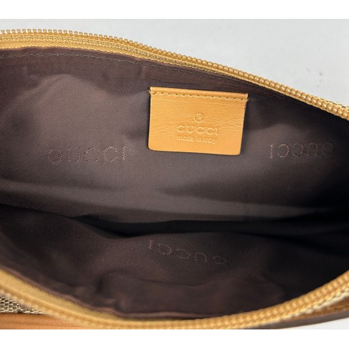 21 - A SMALL GUCCI SHOULDER BAG IN BEIGE, with interlocking 'GG' emblem throughout, tan leather strap and... 