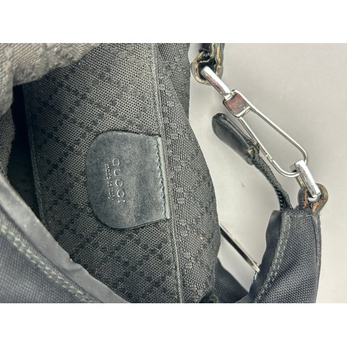 20 - A GUCCI BLACK HANDBAG, with silver coloured hardware

30cm x 20cm 

Good condition. Minimal signs of... 