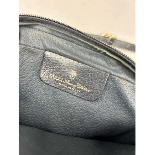 20A - A VINTAGE GUCCI HANDBAG, with blue leather detail and strap. 

25cm x 21cm 

Good condition, minimal... 