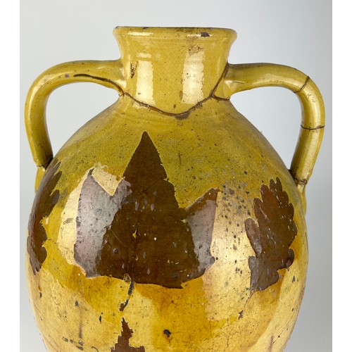 83 - A LARGE YELLOW GLAZED ITALIAN TERRACOTTA VASE WITH PAINTED LEAF AND FERN DESIGN, 

Various repairs

... 