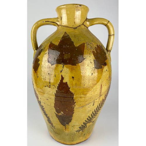 83 - A LARGE YELLOW GLAZED ITALIAN TERRACOTTA VASE WITH PAINTED LEAF AND FERN DESIGN, 

Various repairs

... 