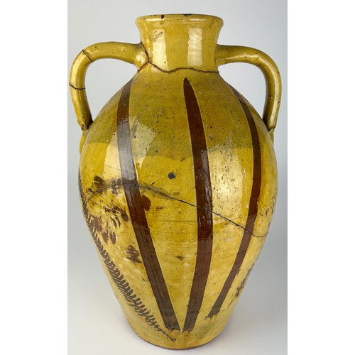 83 - A LARGE YELLOW GLAZED ITALIAN TERRACOTTA VASE WITH PAINTED LEAF AND FERN DESIGN, 

Various repairs

... 