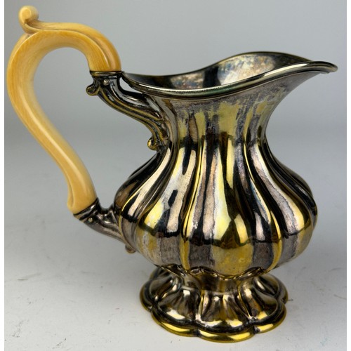 127 - A SILVER PLATED AND GILT JUG WITH BONE HANDLE

12cm in height

**Please note this lot will be availa... 