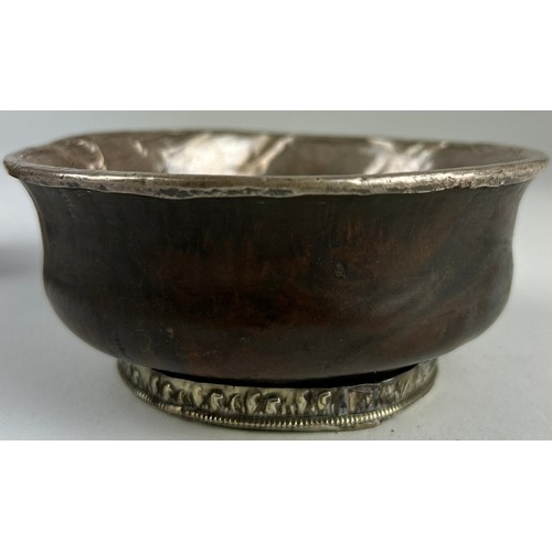 135 - A TIBETAN SILVER AND BURL WOOD CEREMONIAL CUP, 

19th Century, thinly beaten silver applied to the d... 