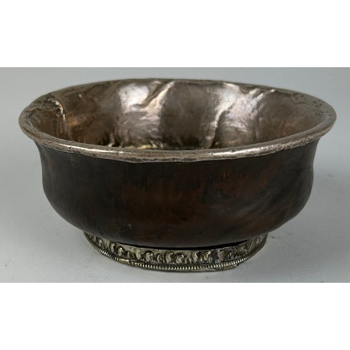 135 - A TIBETAN SILVER AND BURL WOOD CEREMONIAL CUP, 

19th Century, thinly beaten silver applied to the d... 