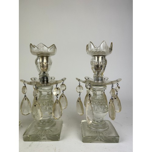 143 - A SET OF FOUR GLASS CANDLESTICKS WITH DROPS (4)

23cm in height

**Please note this lot will be avai... 