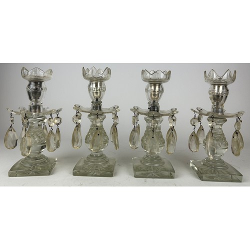 143 - A SET OF FOUR GLASS CANDLESTICKS WITH DROPS (4)

23cm in height

**Please note this lot will be avai... 