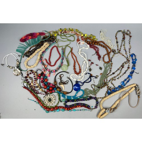 283 - A LARGE QUANTITY OF COSTUME JEWELLERY, to include Chinese jadeite necklace, shells, lapis, mother of... 