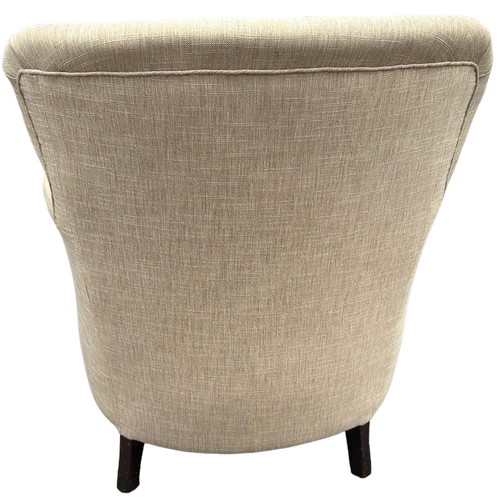 231 - A CONTEMPORARY ARMCHAIR BUTTON BACK UPHOLSTERED IN OATMEAL NEUTRAL FABRIC, raised on turned legs wit... 