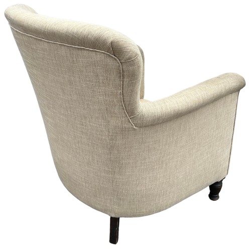 231 - A CONTEMPORARY ARMCHAIR BUTTON BACK UPHOLSTERED IN OATMEAL NEUTRAL FABRIC, raised on turned legs wit... 