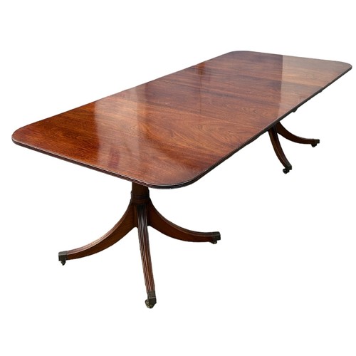 226 - A TWIN PEDESTAL MAHOGANY DINING TABLE PROBABLY BY WILLIAM TILLMAN, two removable leaves, along with ... 