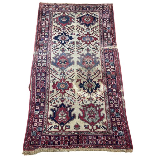 249 - AN ANTIQUE PERSIAN RUG, 

With signs of wear and marks throughout.

225cm x 125cm

**Please note thi... 