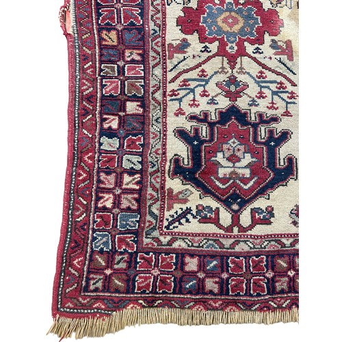 249 - AN ANTIQUE PERSIAN RUG, 

With signs of wear and marks throughout.

225cm x 125cm

**Please note thi... 