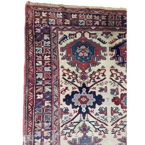 249 - AN ANTIQUE PERSIAN RUG, 

With signs of wear and marks throughout.

225cm x 125cm

**Please note thi... 