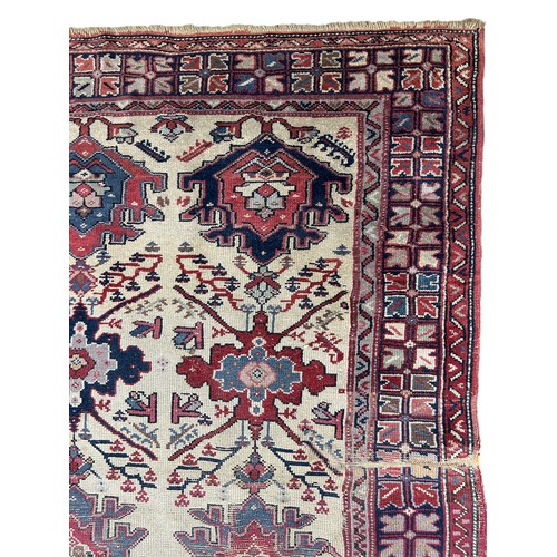 249 - AN ANTIQUE PERSIAN RUG, 

With signs of wear and marks throughout.

225cm x 125cm

**Please note thi... 