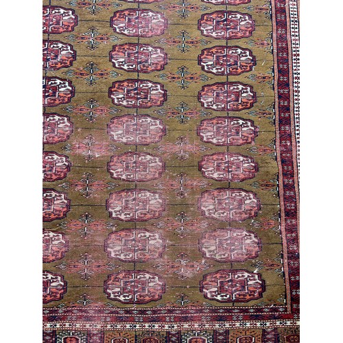 250 - A PERSIAN RUG, 

Faded and damaged

**Please note this lot will be available for collection at an of... 