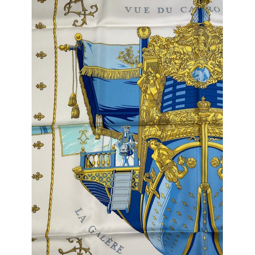 292 - AN HERMES SILK SCARF 'VUE DU CARROSSE DE LA GALERE LA REALE' IN ORIGINAL BOX, apparently unused