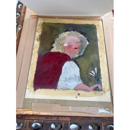 180 - A REVERSE PAINTING ON GLASS OF A CHILD IN A RED CAPE, mounted in an ornately carved leaf and berry f... 