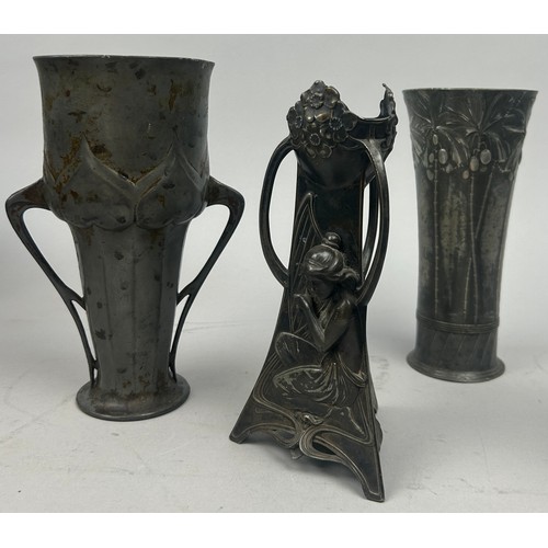 141 - A GROUP OF THREE ART NOUVEAU PEWTER VESSELS, including a twin handled cup (3)

20cm in height