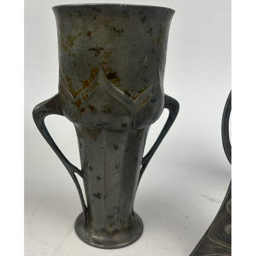 141 - A GROUP OF THREE ART NOUVEAU PEWTER VESSELS, including a twin handled cup (3)

20cm in height