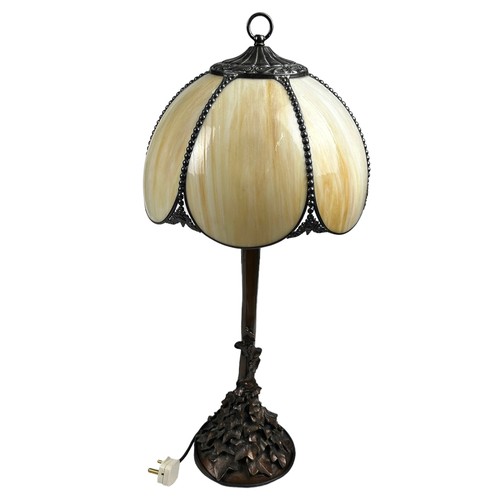 156 - IN THE MANNER OF TIFFANY STUDIOS (1899-1930), faux bronze table lamp naturalistically figured with s... 