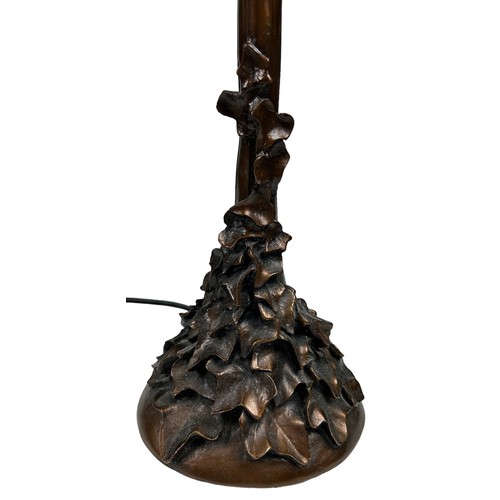 156 - IN THE MANNER OF TIFFANY STUDIOS (1899-1930), faux bronze table lamp naturalistically figured with s... 