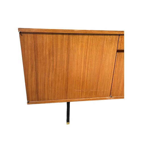 243 - A MID CENTURY TEAK SIDEBOARD, four opening compartments and two central drawers. 

The compartments ... 