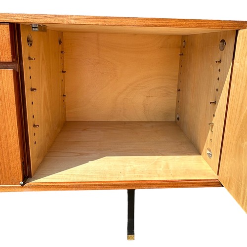 243 - A MID CENTURY TEAK SIDEBOARD, four opening compartments and two central drawers. 

The compartments ... 