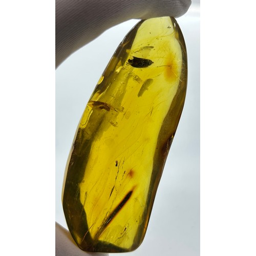 41 - A VERY LARGE FOSSIL AMBER GEMSTONE, 

Very large amber gemstone freeform with a detailed folded leaf... 