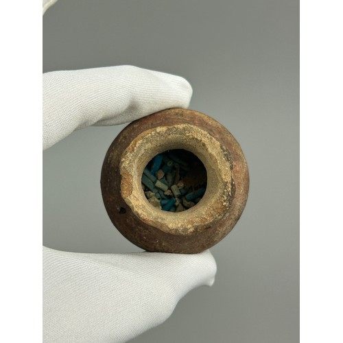 60 - AN ANCIENT EGYPTIAN FUNERARY VESSEL FILLED