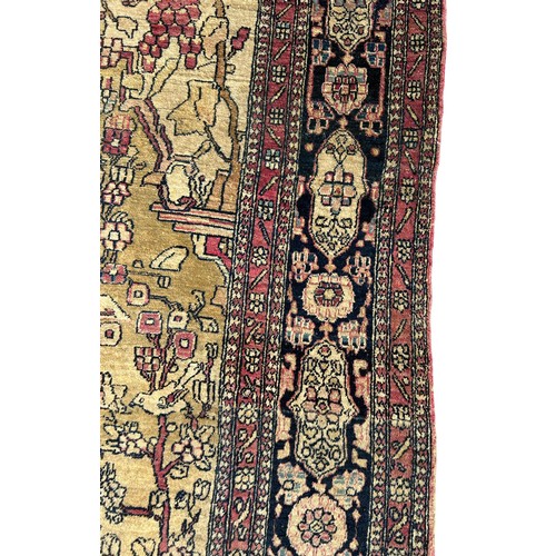 205 - A FINE TURKISH PICTORIAL RUG DEPICTING SMALL BIRDS CRANES AND CATTLE WITH FOLIATE BORDER

205cm x 13... 