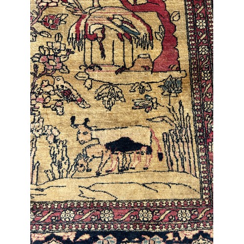 205 - A FINE TURKISH PICTORIAL RUG DEPICTING SMALL BIRDS CRANES AND CATTLE WITH FOLIATE BORDER

205cm x 13... 