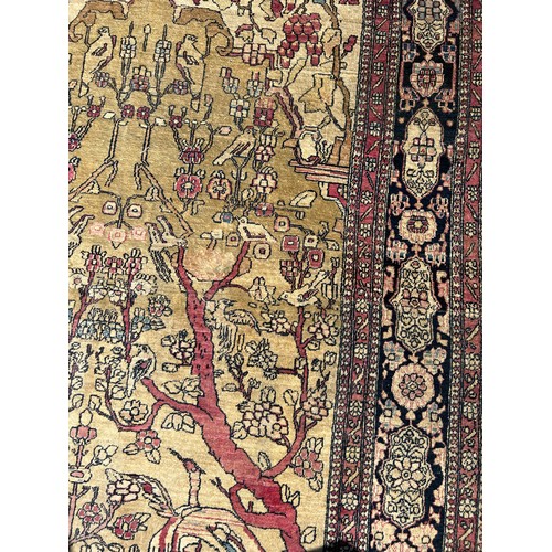 205 - A FINE TURKISH PICTORIAL RUG DEPICTING SMALL BIRDS CRANES AND CATTLE WITH FOLIATE BORDER

205cm x 13... 