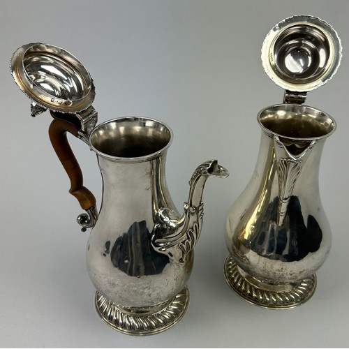 58 - A GEORGE V SILVER COFFEE POT AND HOT WATER JUG, each having a gadroon rim and pineapple finial each ... 