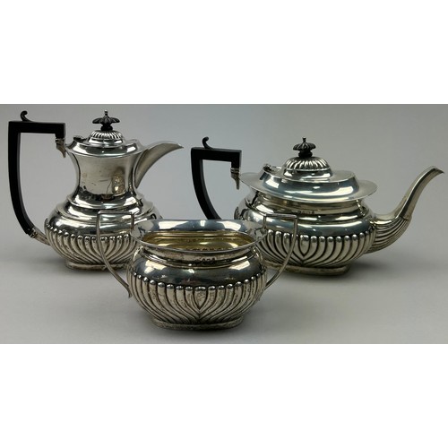 59 - A MATCHED SILVER TEA SET, comprising two tea pots and a sugar bowl, each having a gadrooned edge. 

... 