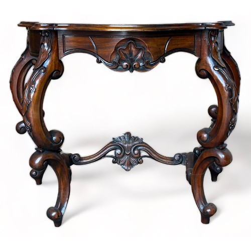 190 - A REPRODUCTION MAHOGANY CONSOLE TABLE IN THE ROCOCCO STYLE, ornately carved with S scrolls and C scr... 