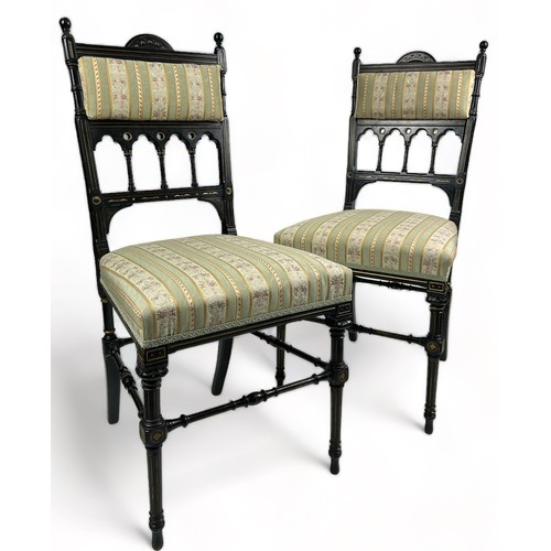 180 - A PAIR OF AESTHETIC MOVEMENT EBONISED SIDE CHAIRS OF GOTHIC DESIGN, with pierced back rail of shaped... 