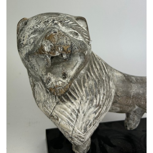 241 - A SCULPTURAL LIMED WOODEN FIGURE OF A LION, mounted on an ebonised stand

30cm x 25cm

**Please note... 