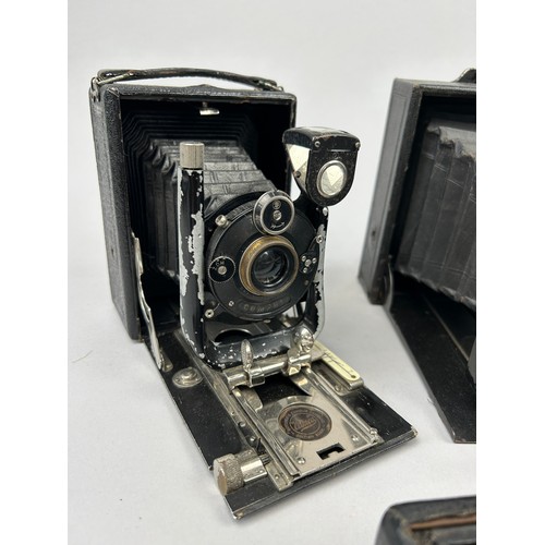 244 - A COLLECTION OF EIGHT DECORATIVE VINTAGE CAMERAS