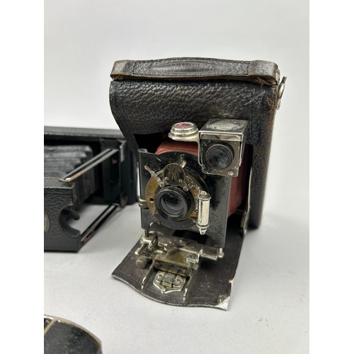 244 - A COLLECTION OF EIGHT DECORATIVE VINTAGE CAMERAS