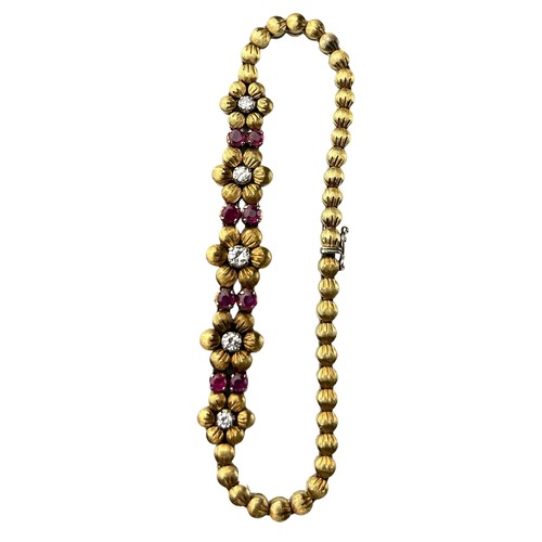 64A - AN 18CT GOLD LADIES FLOWER BRACELET WITH RUBIES AND DIAMONDS, 

Marked 750.

Total length 18cm

Tota... 