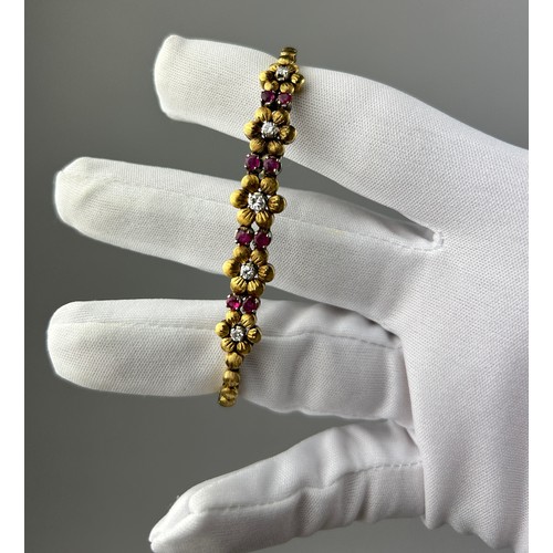 64A - AN 18CT GOLD LADIES FLOWER BRACELET WITH RUBIES AND DIAMONDS, 

Marked 750.

Total length 18cm

Tota... 