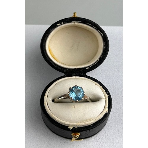 35 - A PLATINUM RING INSET WITH A BLUE GEMSTONE most likely aquamarine, within a small black case.  

Wei... 