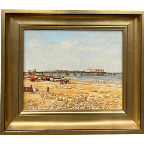 286 - AN OIL ON BOARD PAINTING OF A PEBBLE AND SAND BEACH WITH SAILBOATS AND A PIER, 

Signed indistinctly... 