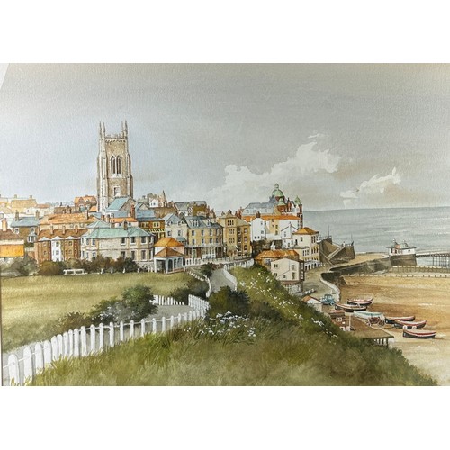 298 - A WATERCOLOUR ON PAPER OF A COASTAL TOWN WITH BEACH AND SEA IN THE DISTANCE, 

Unsigned. Mounted in ... 