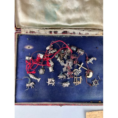 54 - AN UNUSUAL COLLECTION OF CHINESE SILVER CHARMS, 

To include dragon, tiger, sedan chair and many oth... 