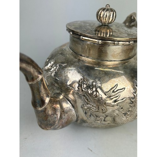 63 - A CHINESE EXPORT SILVER TEA SET WITH FOUR CLAWED DRAGONS MARKED HC MOST PROBABLY HUNG CHONG AND CO O... 