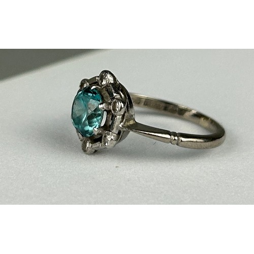 35 - AN 18CT WHITE GOLD RING inset with an blue topaz stone mounted in a hexagonal setting with six diamo... 