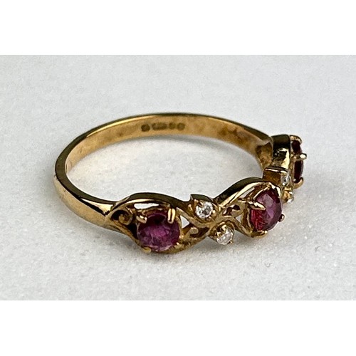 28 - A 9CT GOLD RING INSET WITH THREE SMALL RUBIES AND FOUR SMALL DIAMONDS